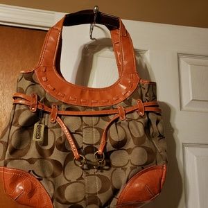 Color is Orange and Brown  Coach    Hand   Bag